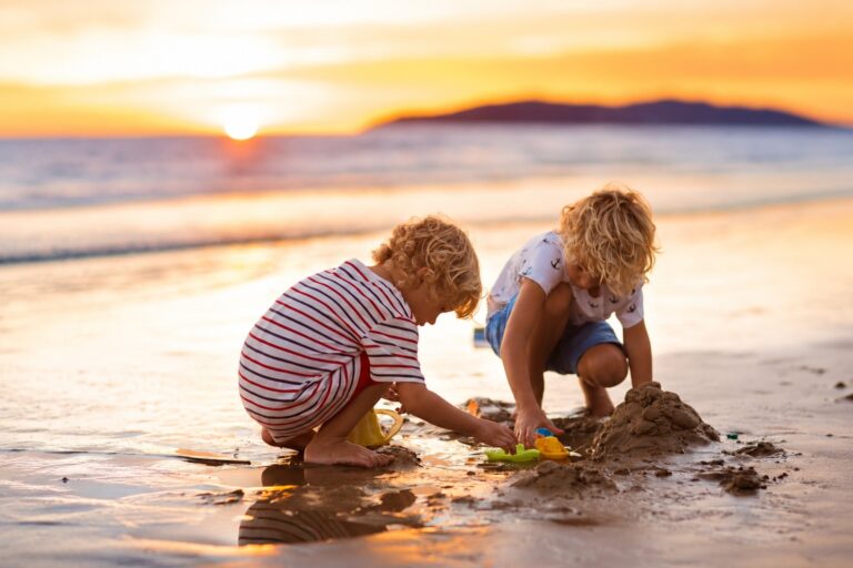 children playing on the beach at sunset andalusia