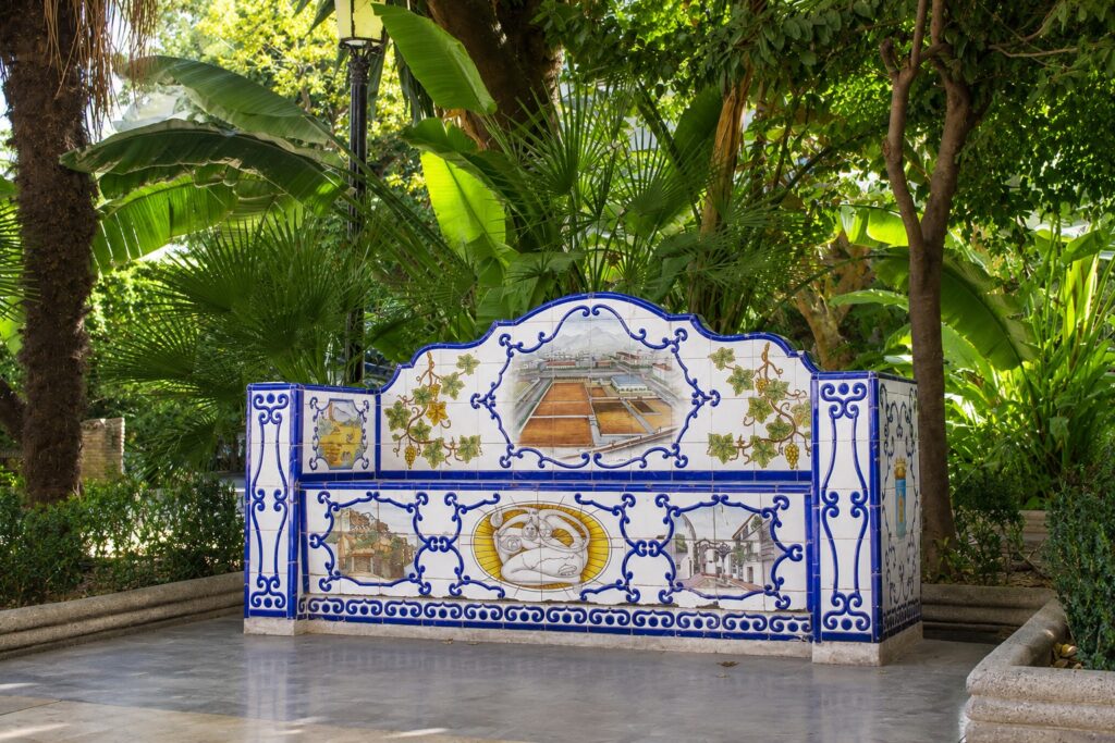 tropical garden with spanish tile bench in malaga