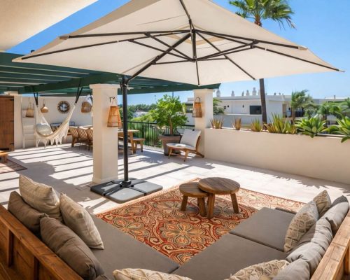 Balcony with lounge seating area and view in Marbella apartment